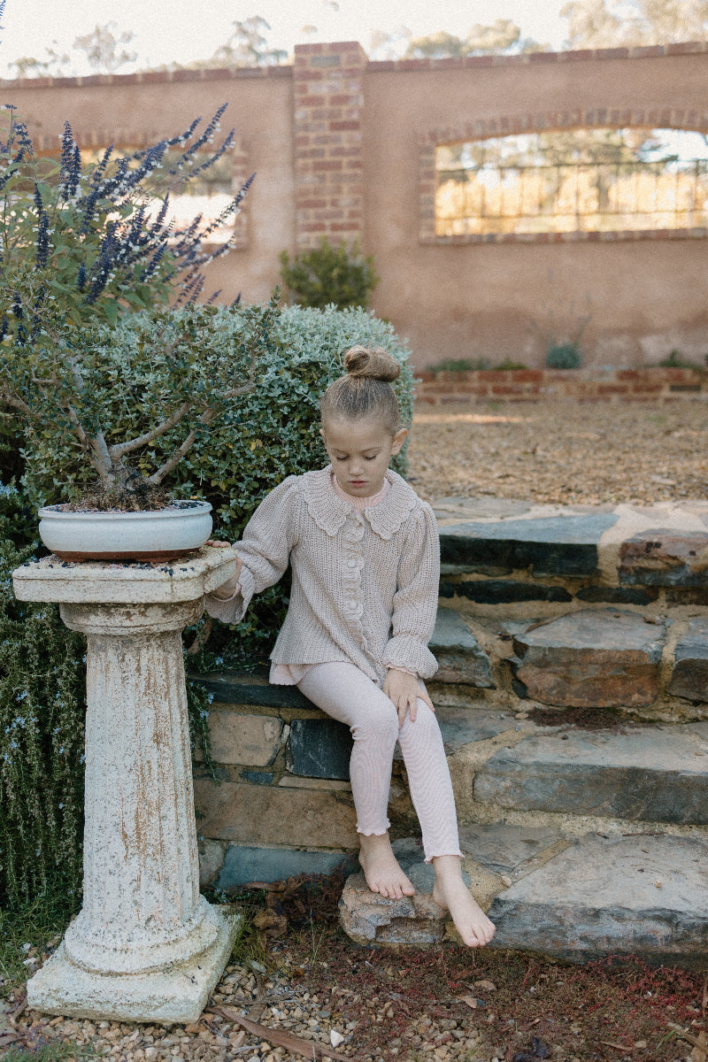 a young child wearing a Kenya Cardigan
