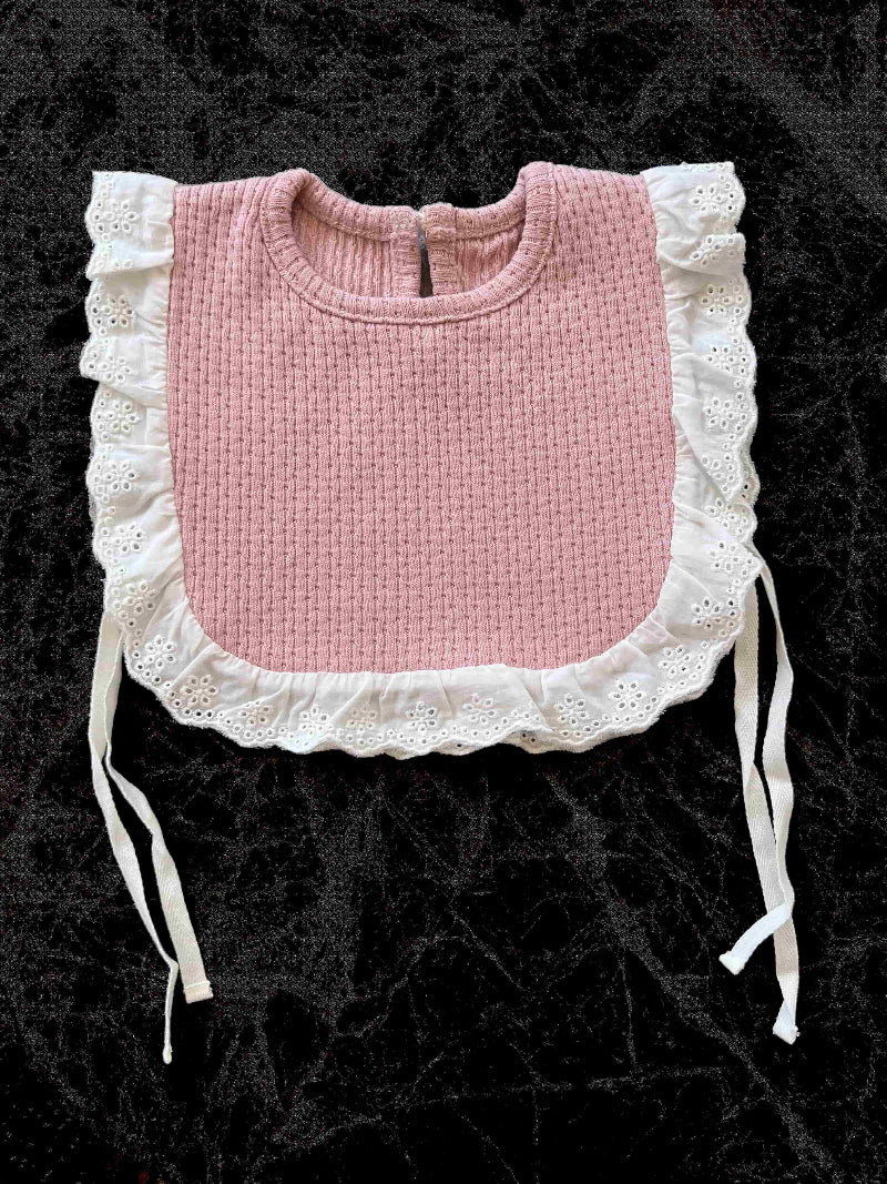 Knitted Lace Frill Bib in Pink on a black background