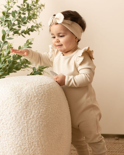 baby wearing a Frilled Apple Onesie in Beige