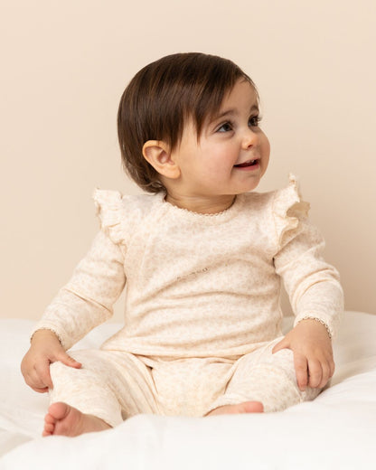 baby wearing a Frilled Apple Onesie in Floral