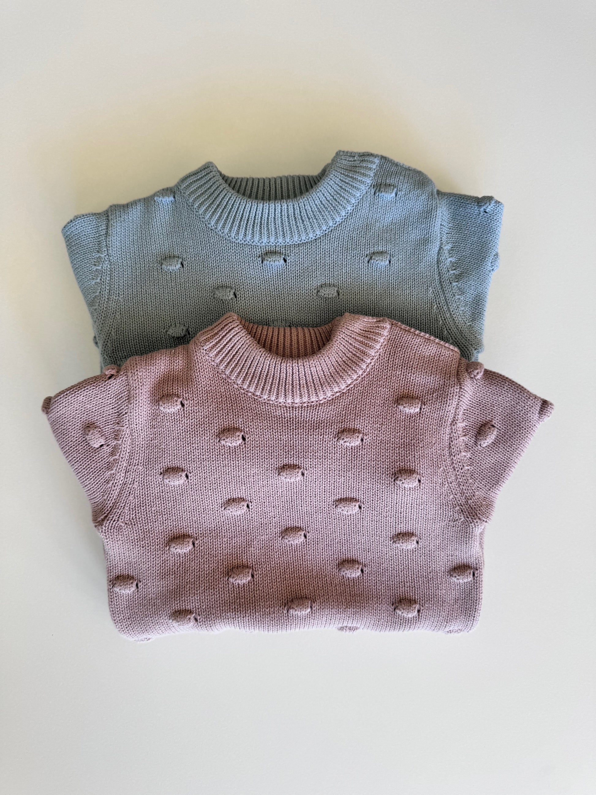 Knitted Romper in Dusty Pink and Sky Blue on a white background 