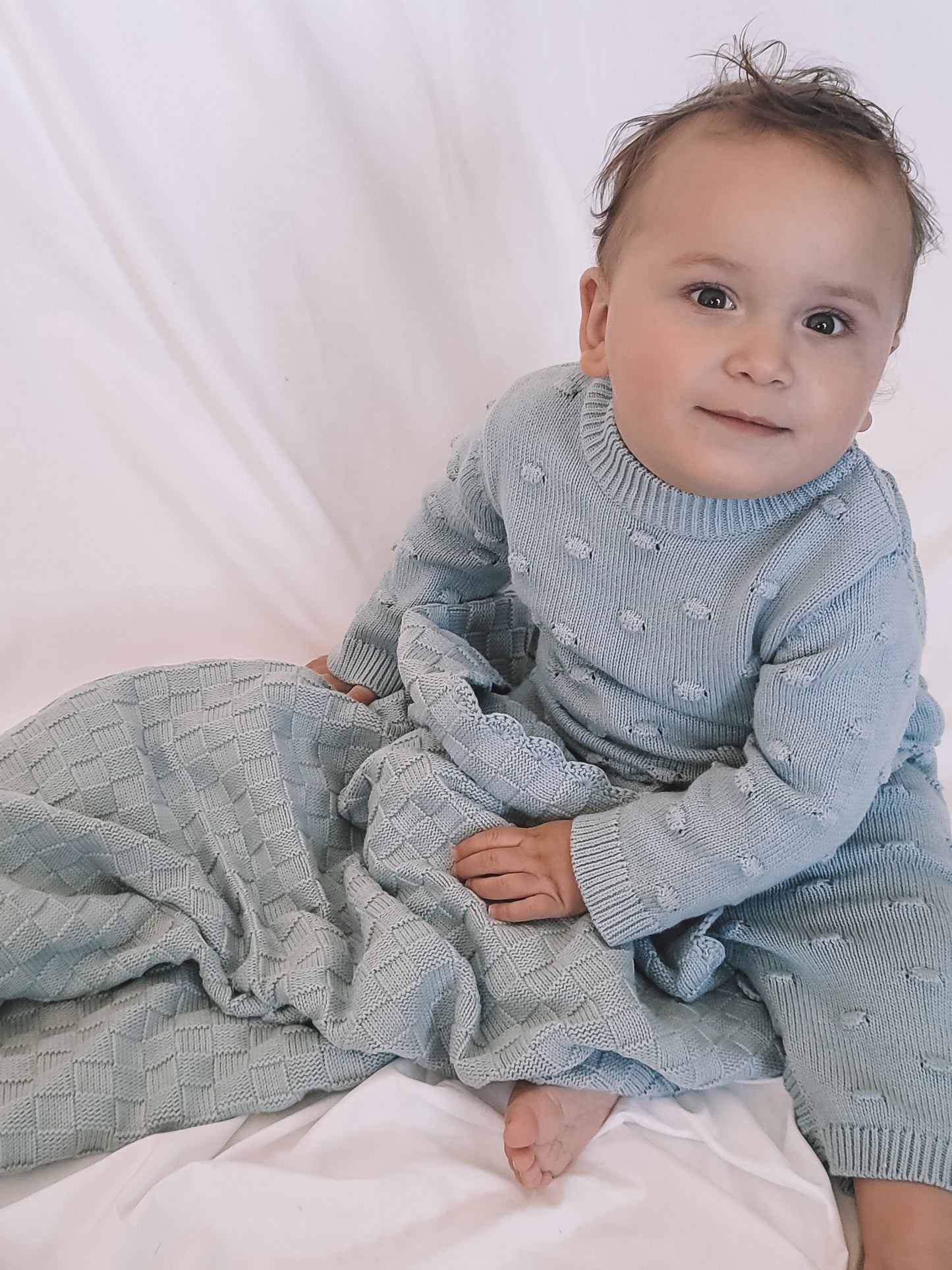 baby wearing a Knitted Romper in Sky Blue 