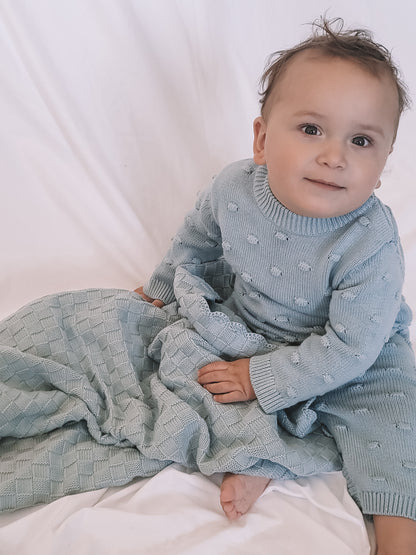 baby wearing a Knitted Romper in Sky Blue 