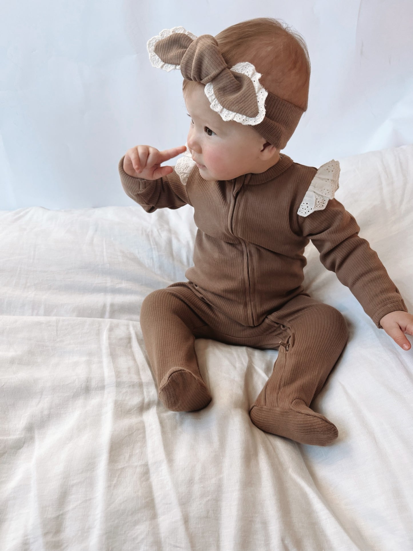 A baby wearing a Lace Headband in Chocolate
