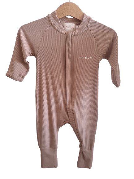 Lightweight Eco Onesie in Beige  with a hood on a hanger against a checkerboard transparency pattern