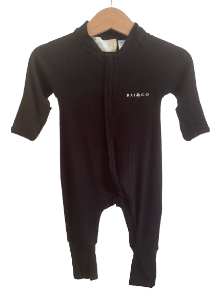 Lightweight Eco Onesie in Black with a brand logo on a hanger against a checkerboard transparency pattern 