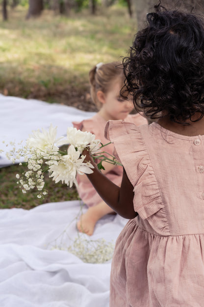 A child wearing a Lou Lou Frilled Dress With Pilchers in Pink 