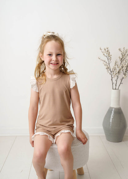 Young girl wearing a Mini Ribbed Lace Frill in Beige