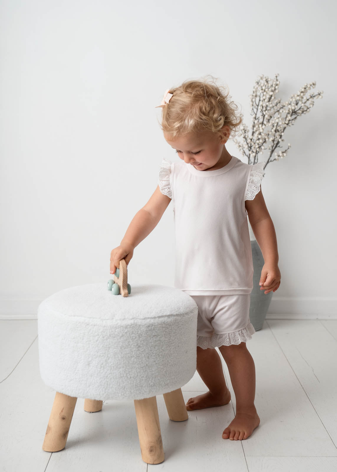 Baby wearing a Mini Ribbed Lace Frill in White 