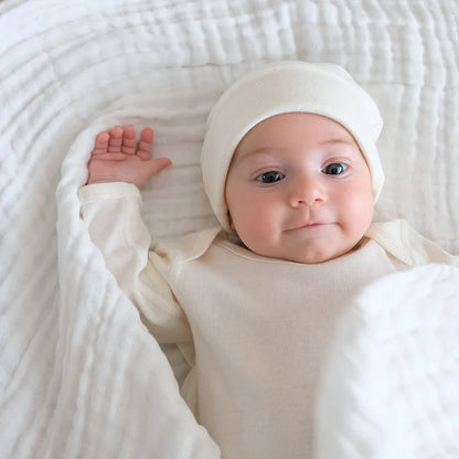 Baby wrapped in Organic Undyed Cotton Muslin Wrap in White