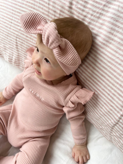 a baby wearing a Ribbed Knotted Headbands in Light Pink 