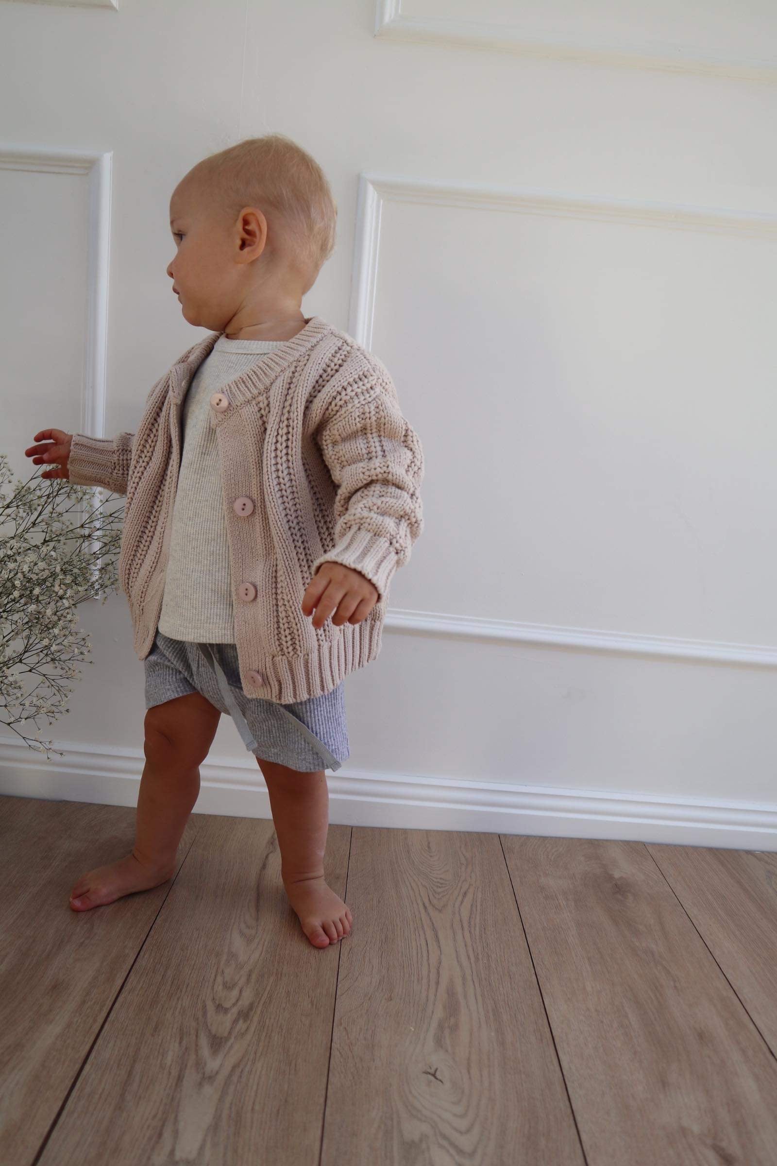 Baby wearing a Chunky Knitted Cardigan in Beige 