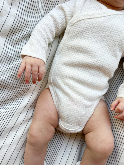 Baby wearing a Knitted Button Kimono in White