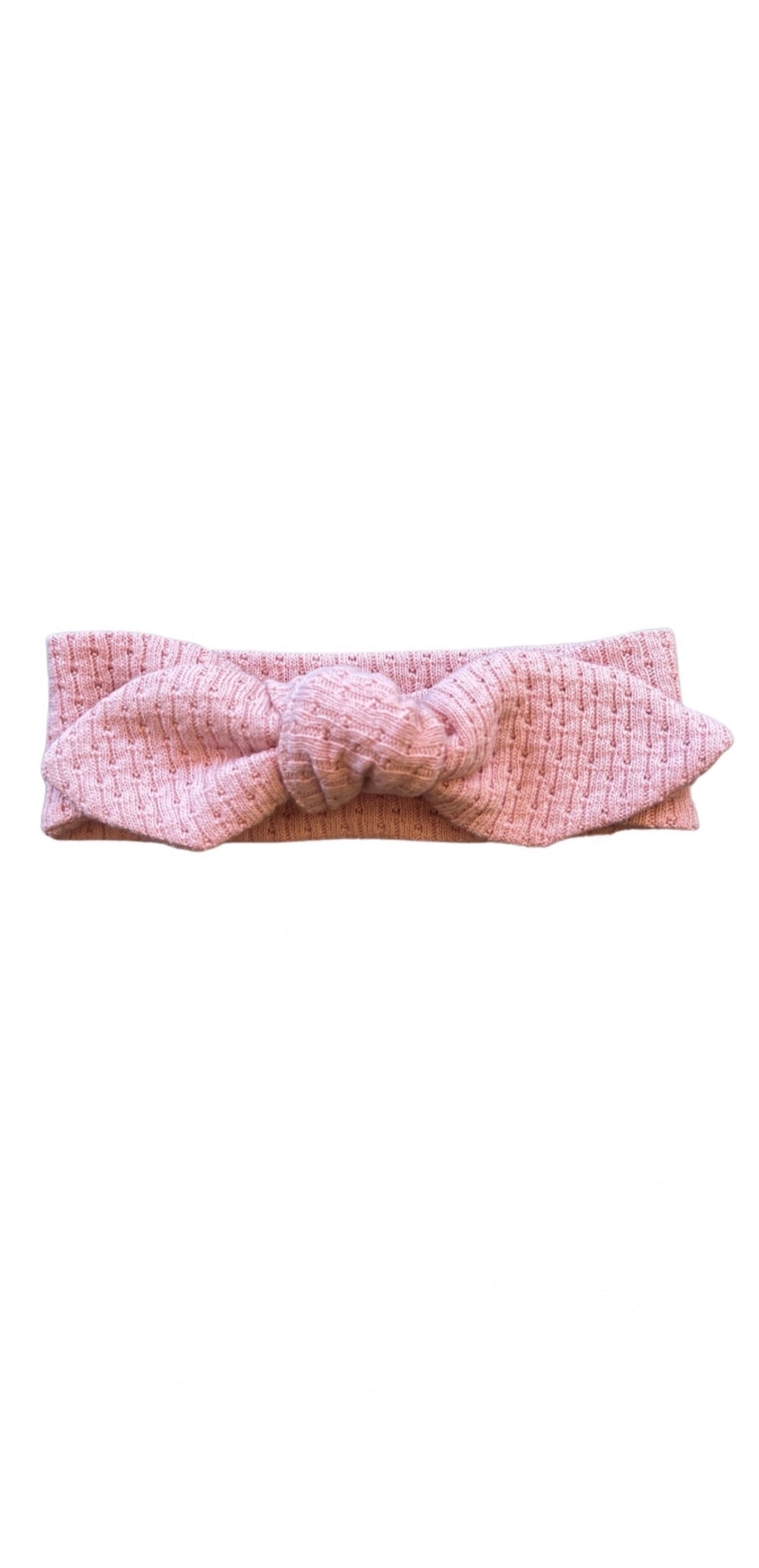 Knitted Knot Headband in Pink on a white background