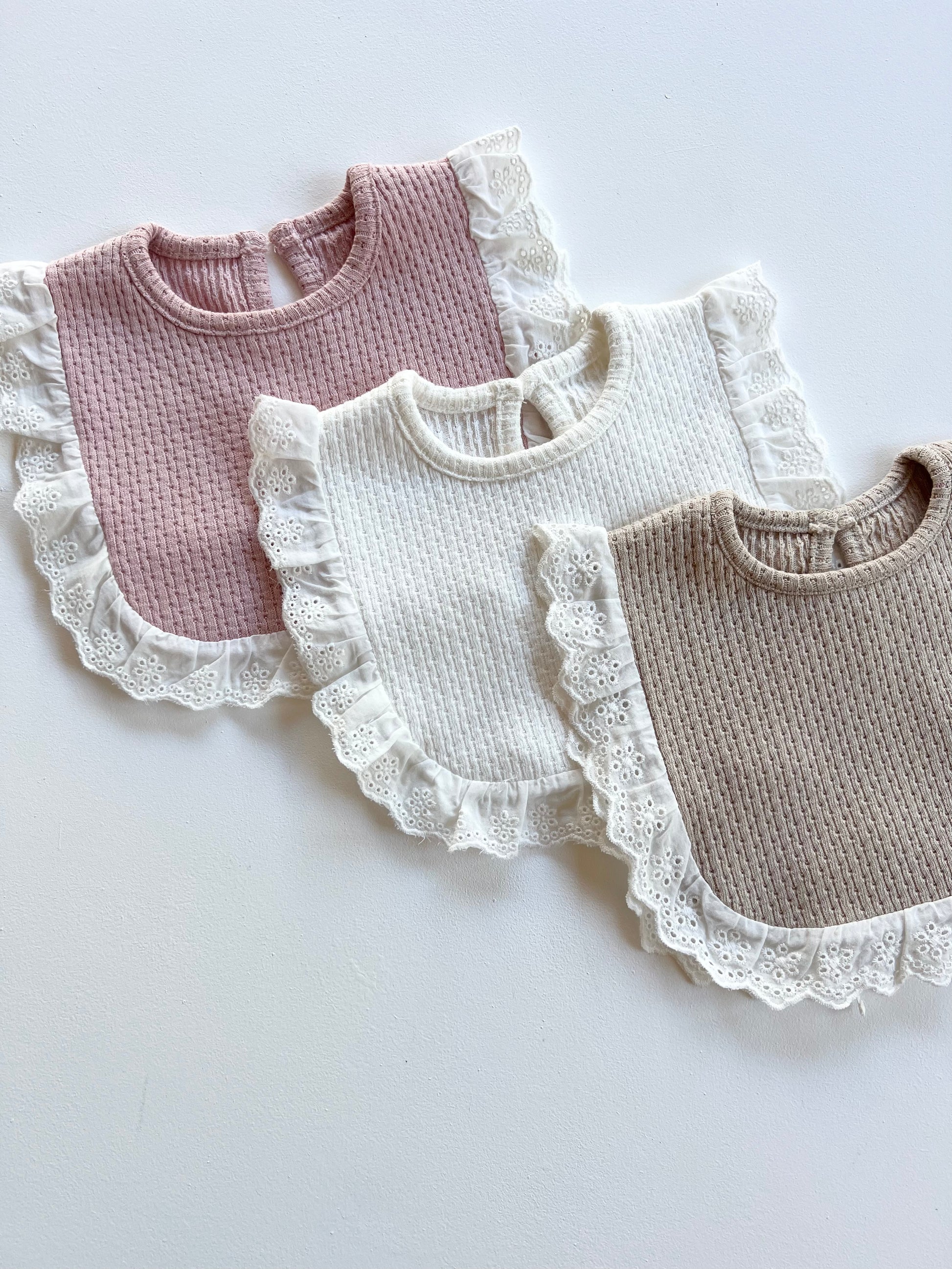Knitted Lace Frill Bib on Available Colours on a white background