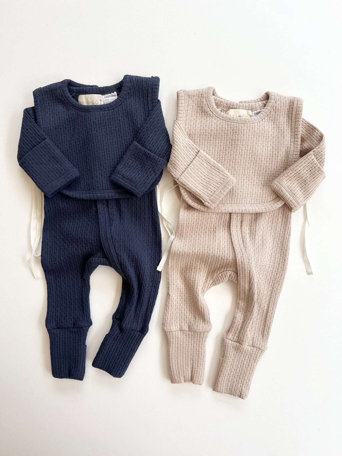 Knitted Plain Bib in Navy and Beige on a white background
