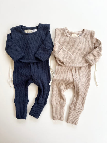 Knitted Plain Bib in Navy and Beige on a white background